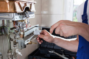 project for boiler repair in st albans -work carried out for boiler repair in st albans - image shows our engineer working on a baxi boiler